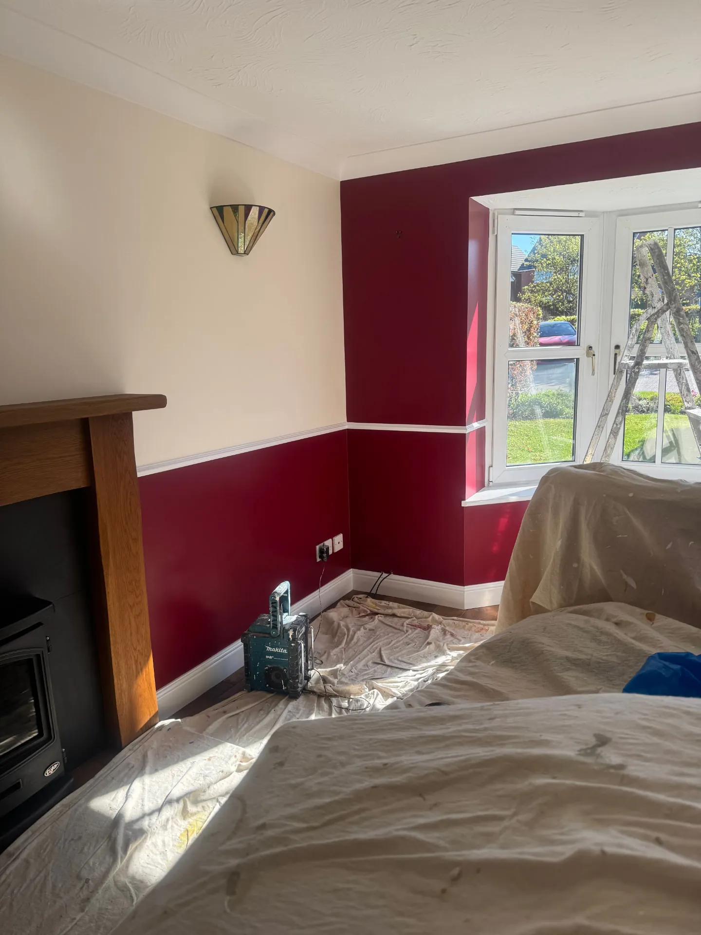 Living room in Bonnyrigg freshly painted in deep burgundy below a white dado rail by W J Crighton, with crisp white skirtings and cornice