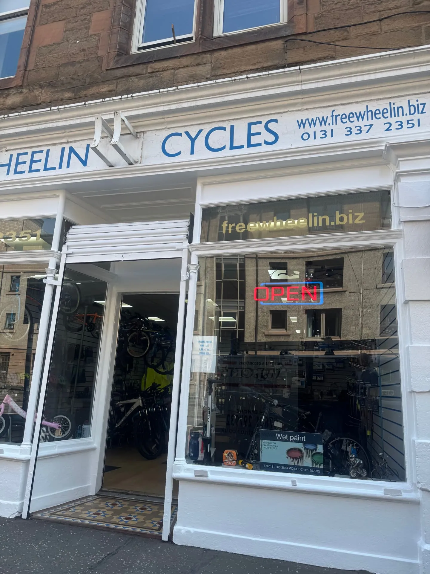 Commercial decorating in Edinburgh — repainted white shopfront and window frames by W J Crighton