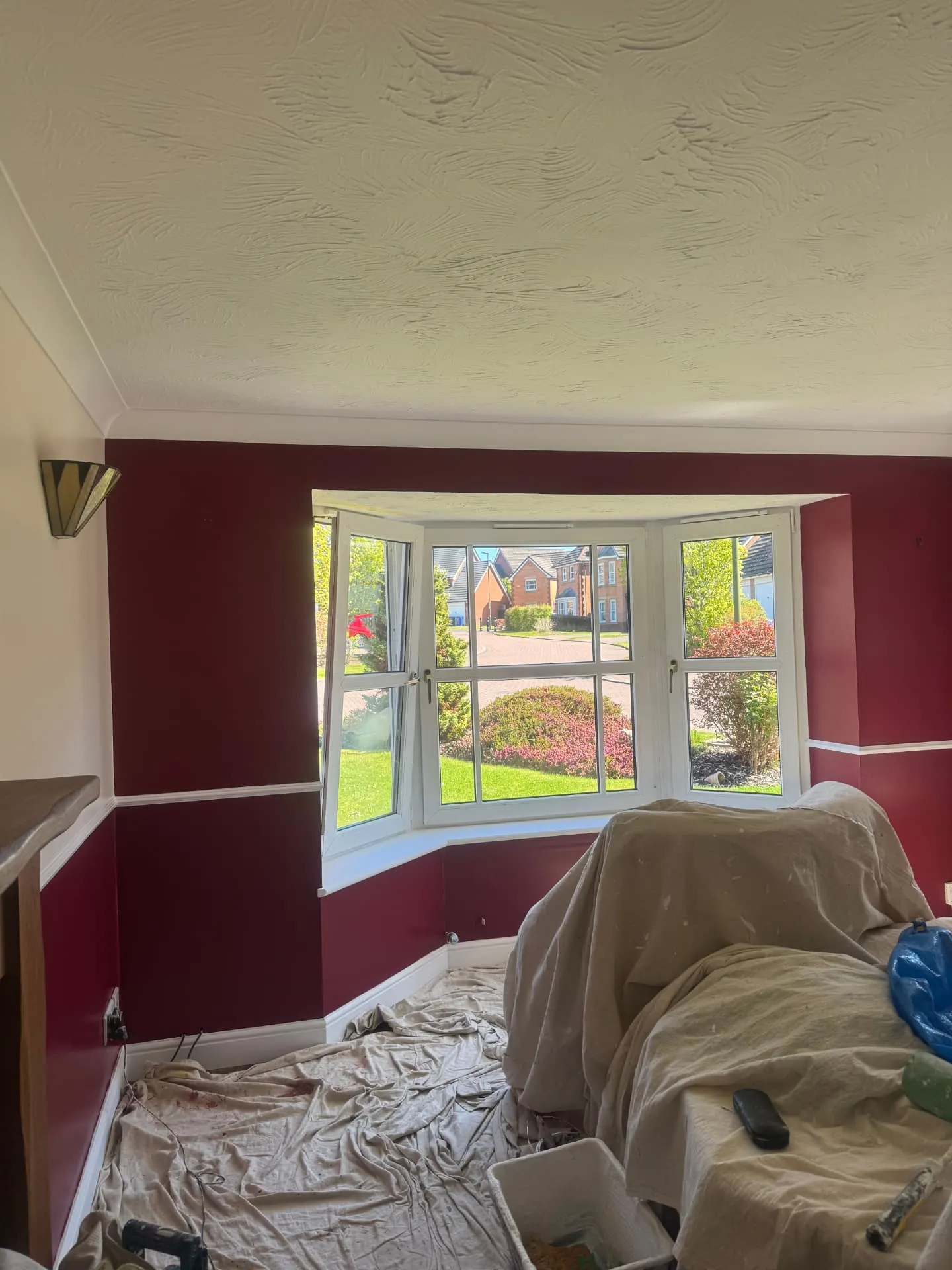 Bay window surround in a Midlothian lounge painted burgundy with white woodwork by W J Crighton