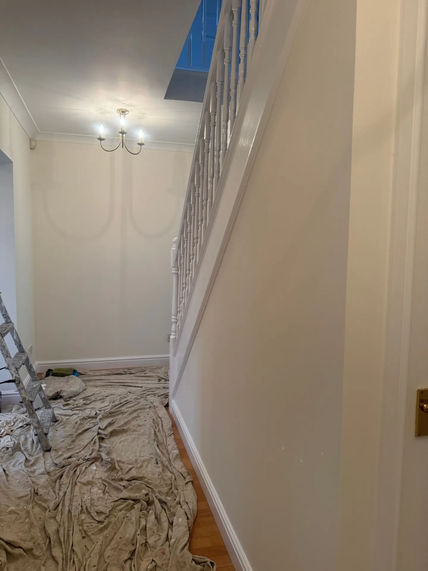 Stairwell wall and balustrade repainted in Bonnyrigg, spindles and handrail glossed by W J Crighton