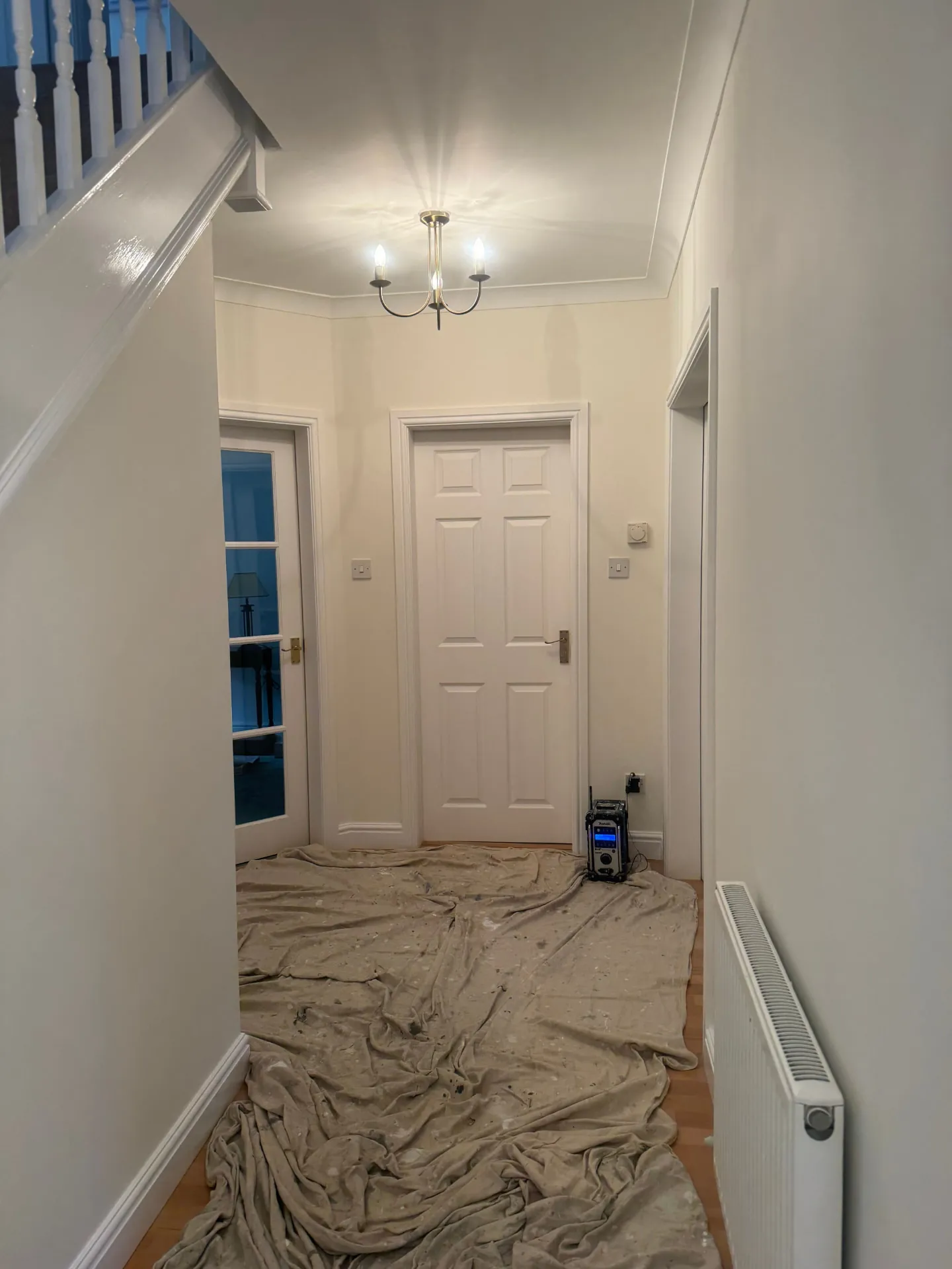 Hallway and stairwell in Bonnyrigg finished in soft white with glossed woodwork by W J Crighton